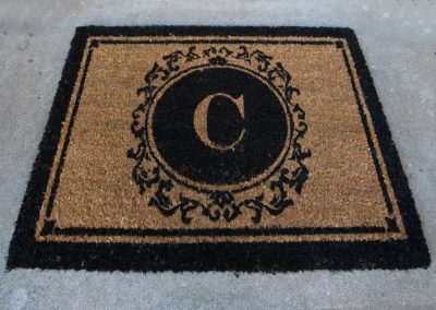 Front door mat with C insignia