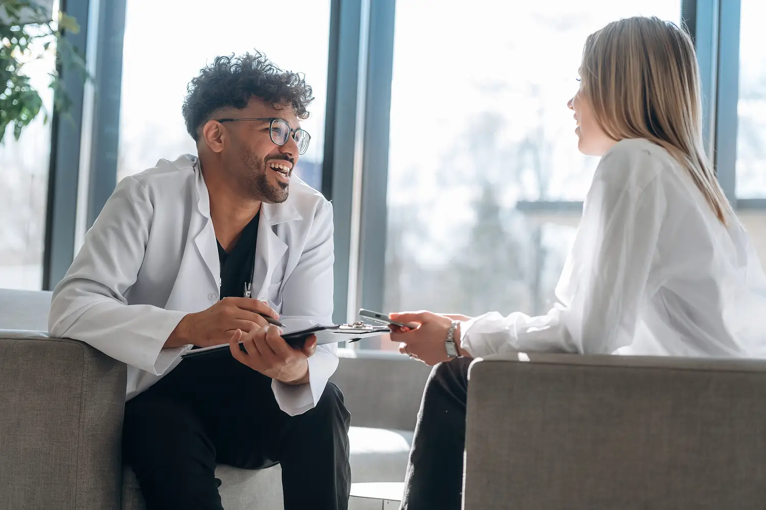 a man and woman in white coats talking