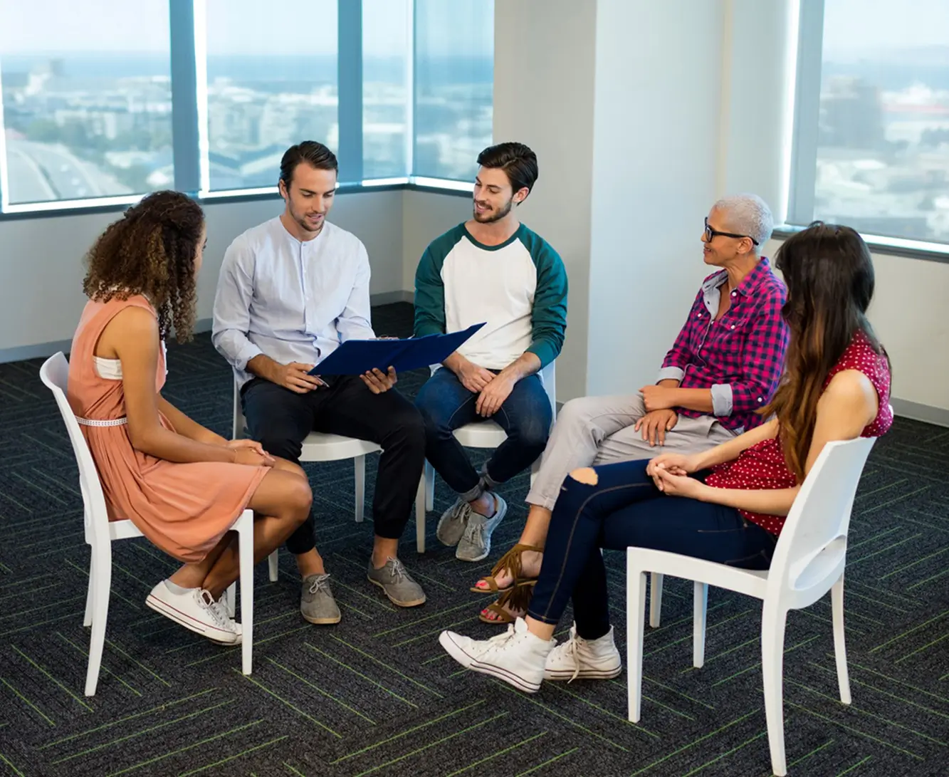 a group of people sitting in chairs